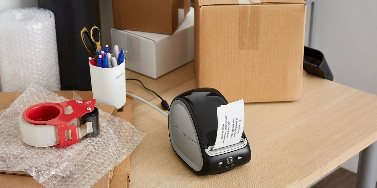 DYMO LabelWriter label printer printing a shipping label on a packing desk