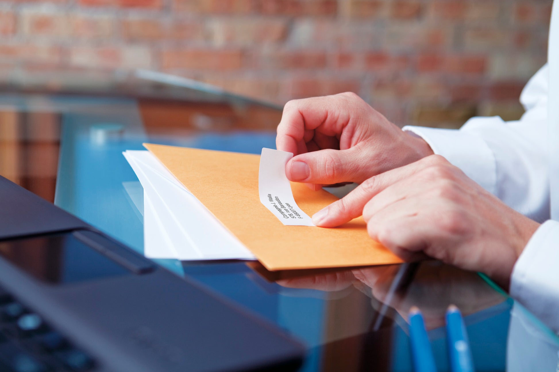 Printed DYMO address labels applied to rolled documents and mailing sheets in an office filing environment