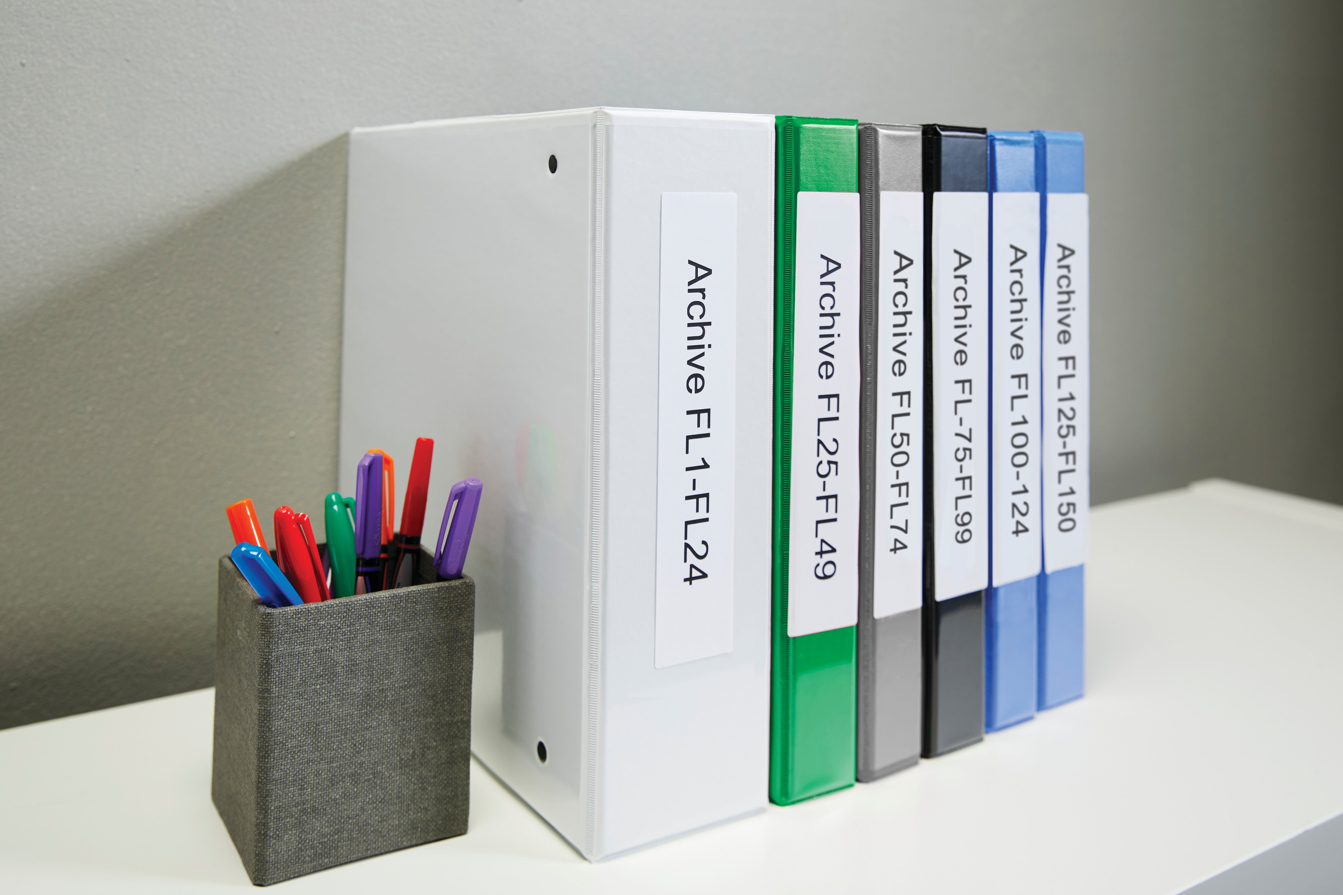 Lever arch file labels used on office binders and shelf organisers