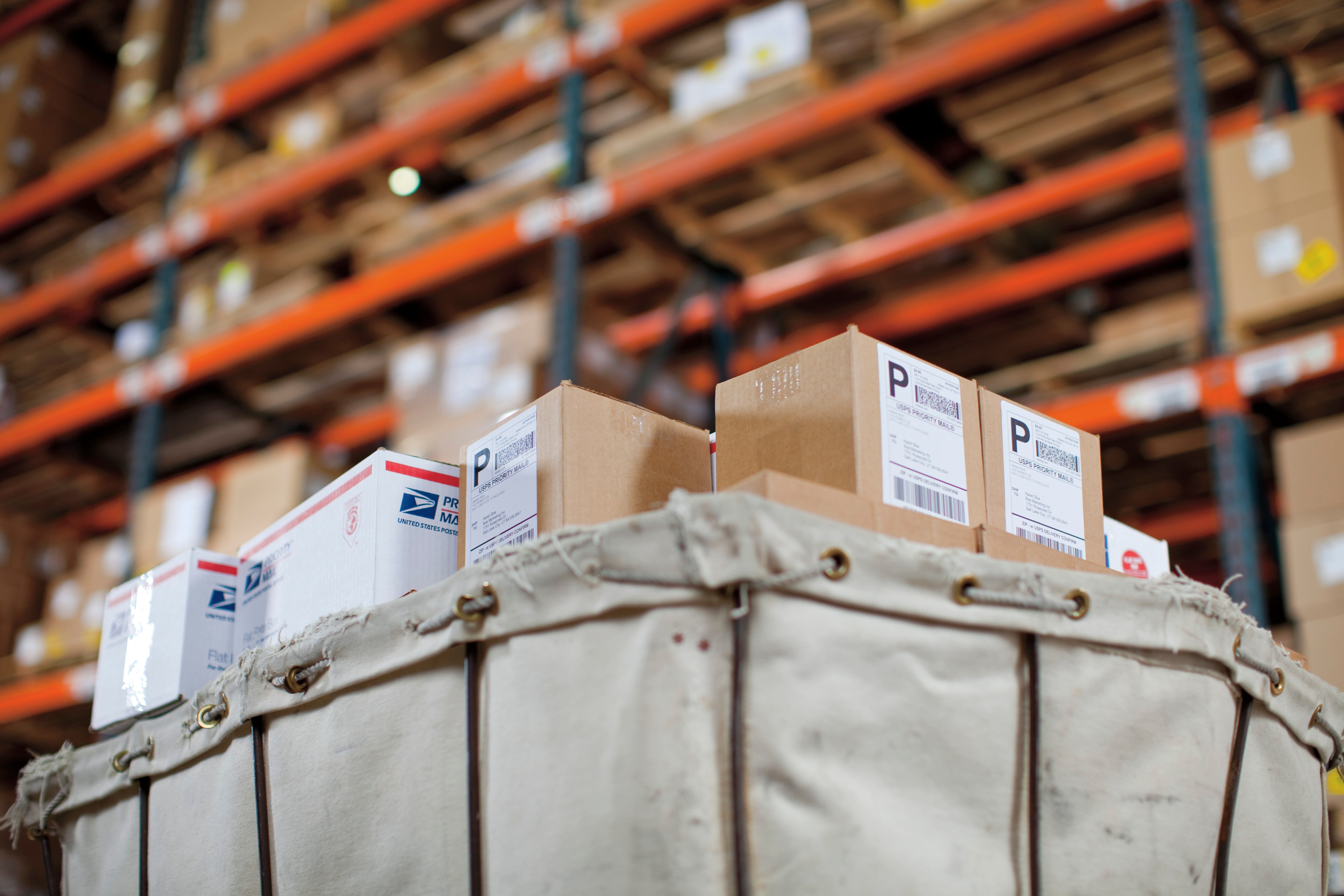 Warehouse shelving with labelled storage containers