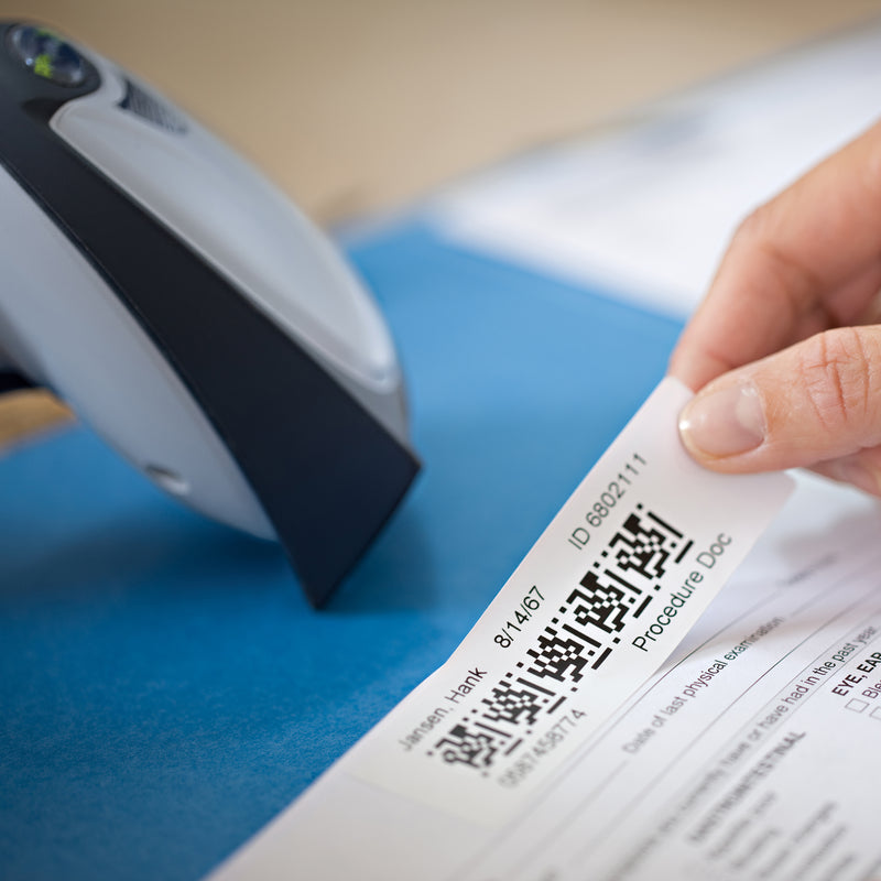 Printed address label being applied to a blue envelope