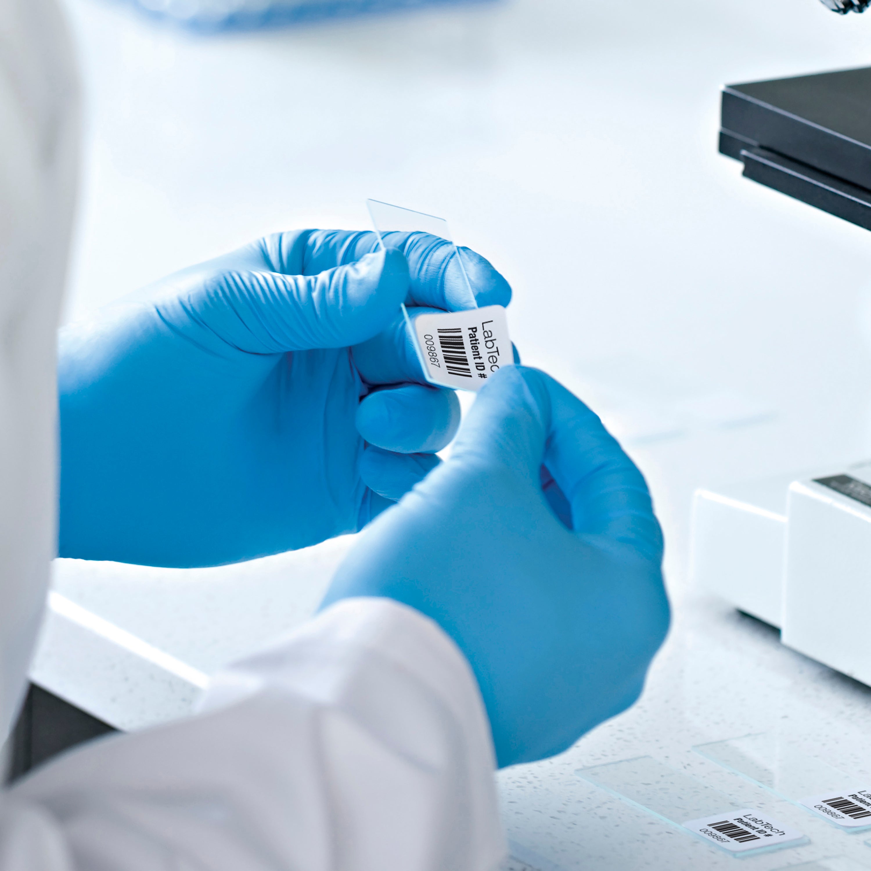 Blue gloves in laboratory with barcode style label attached