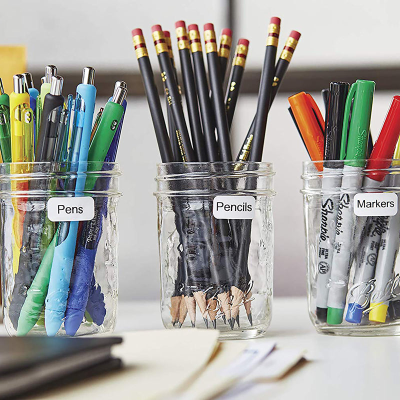 Labelled jars and containers holding paintbrushes and art supplies