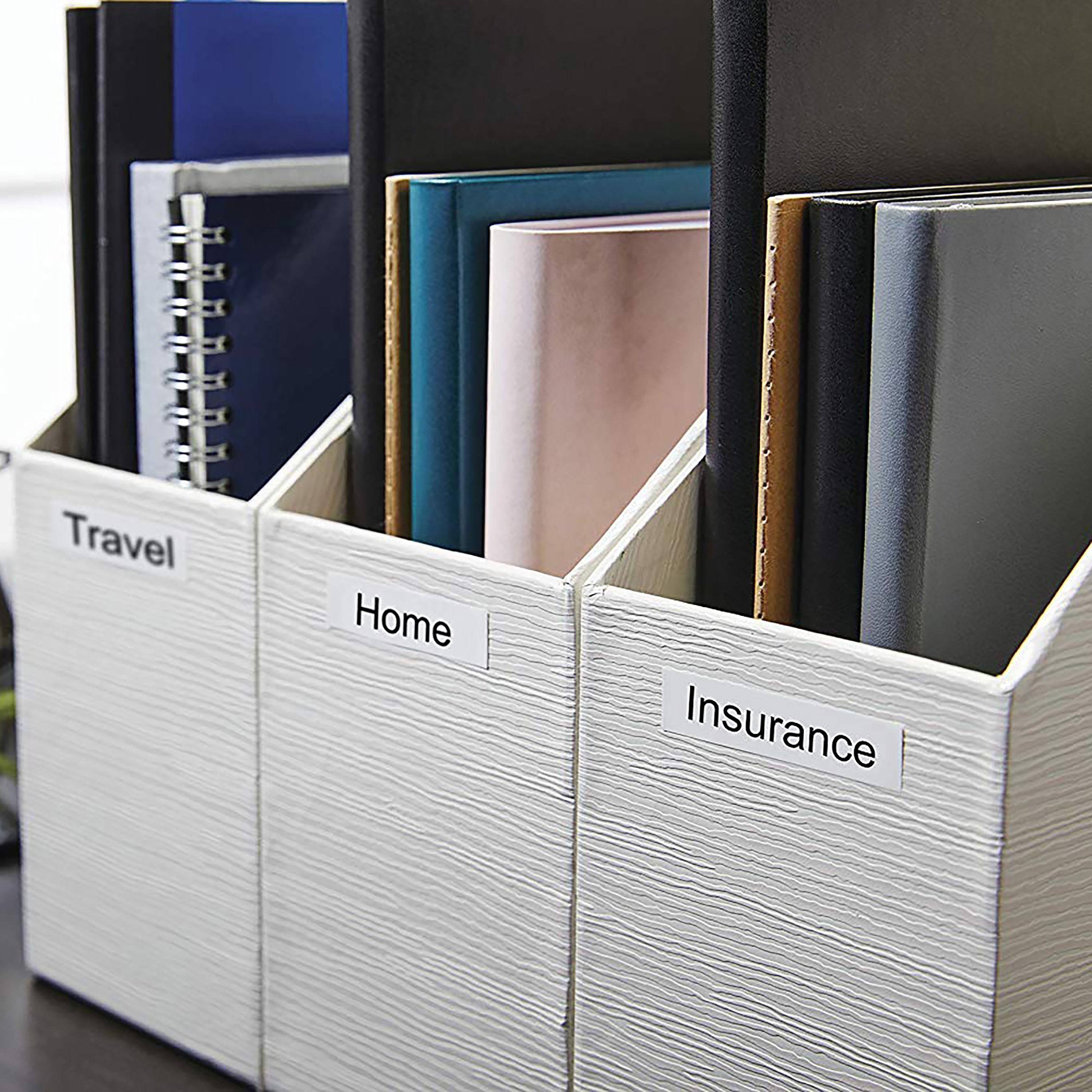 White magazine holders storing folders and documents upright