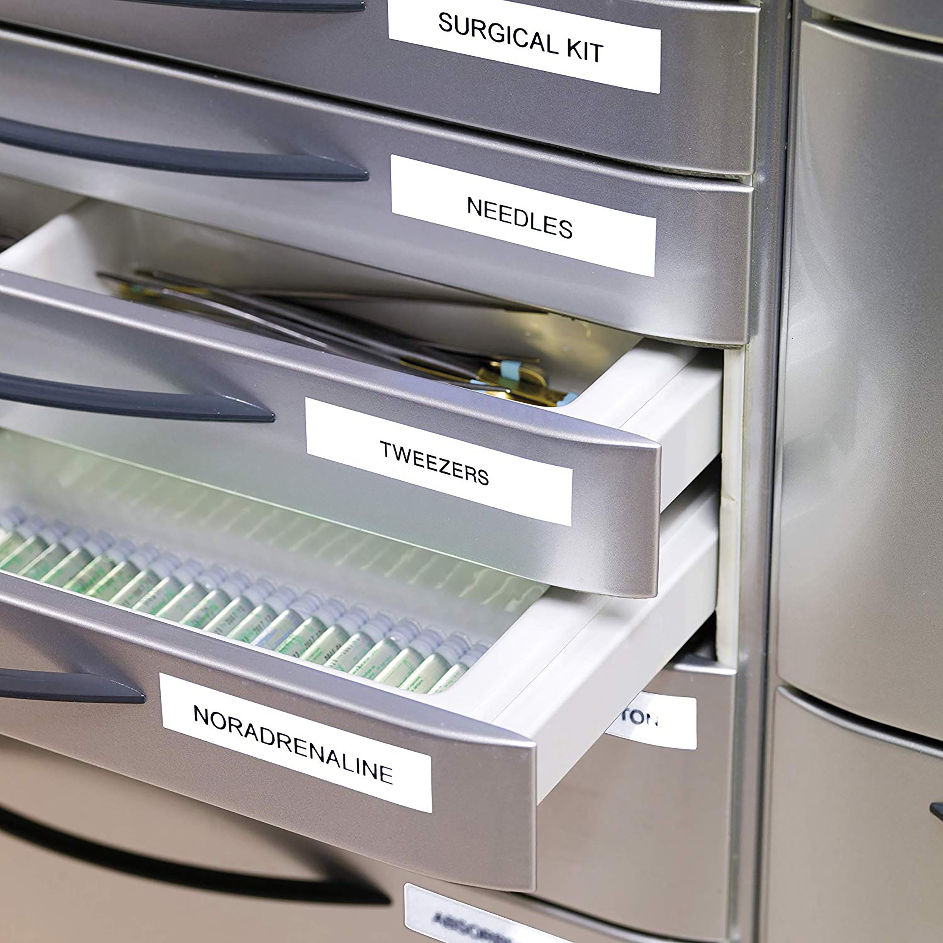 White labelled storage drawers in an organised filing cabinet