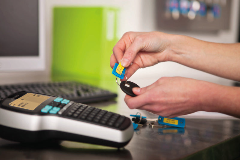 Person using a DYMO LabelManager 420P to create labelled key tags for organised key management