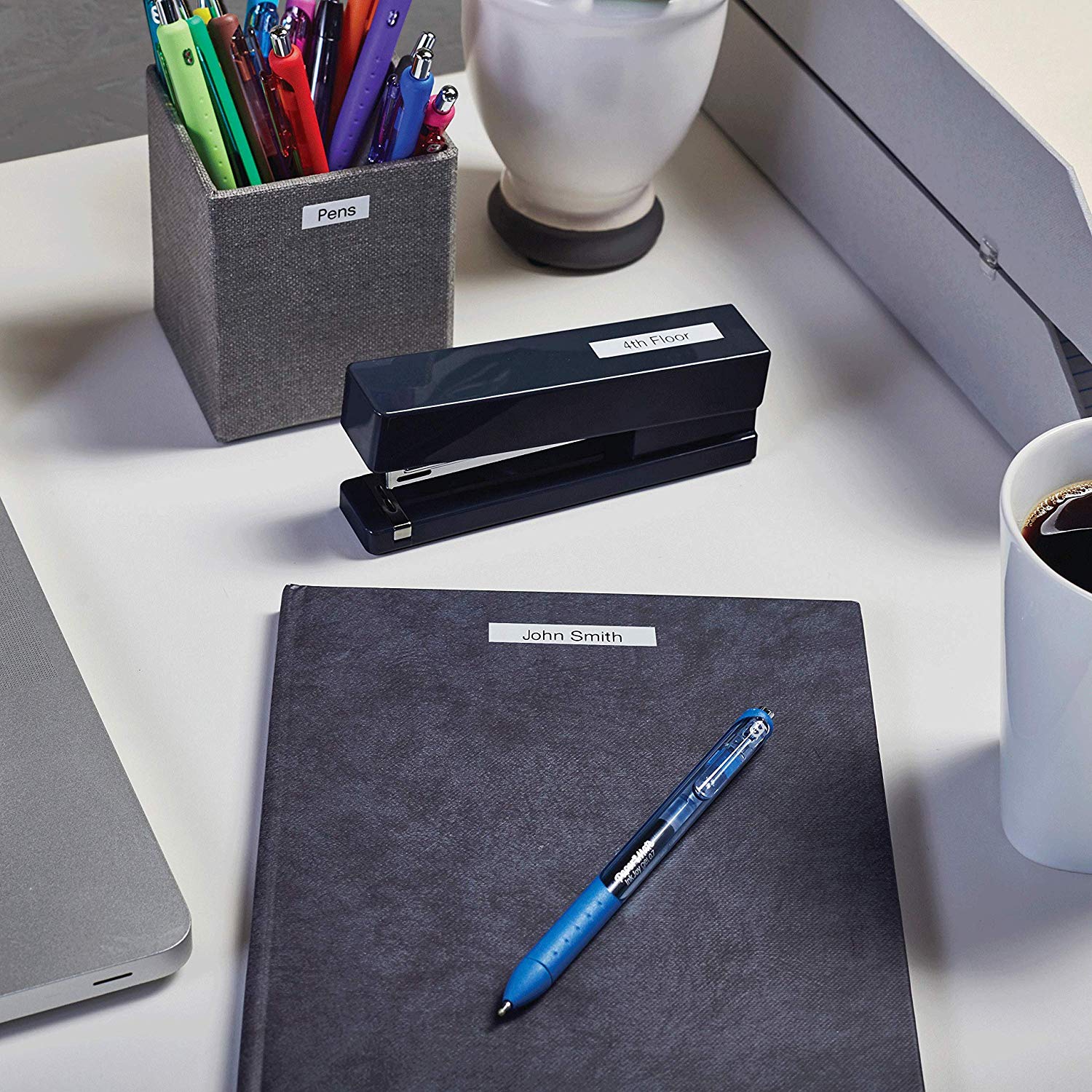 Label maker beside stationery and office desk accessories