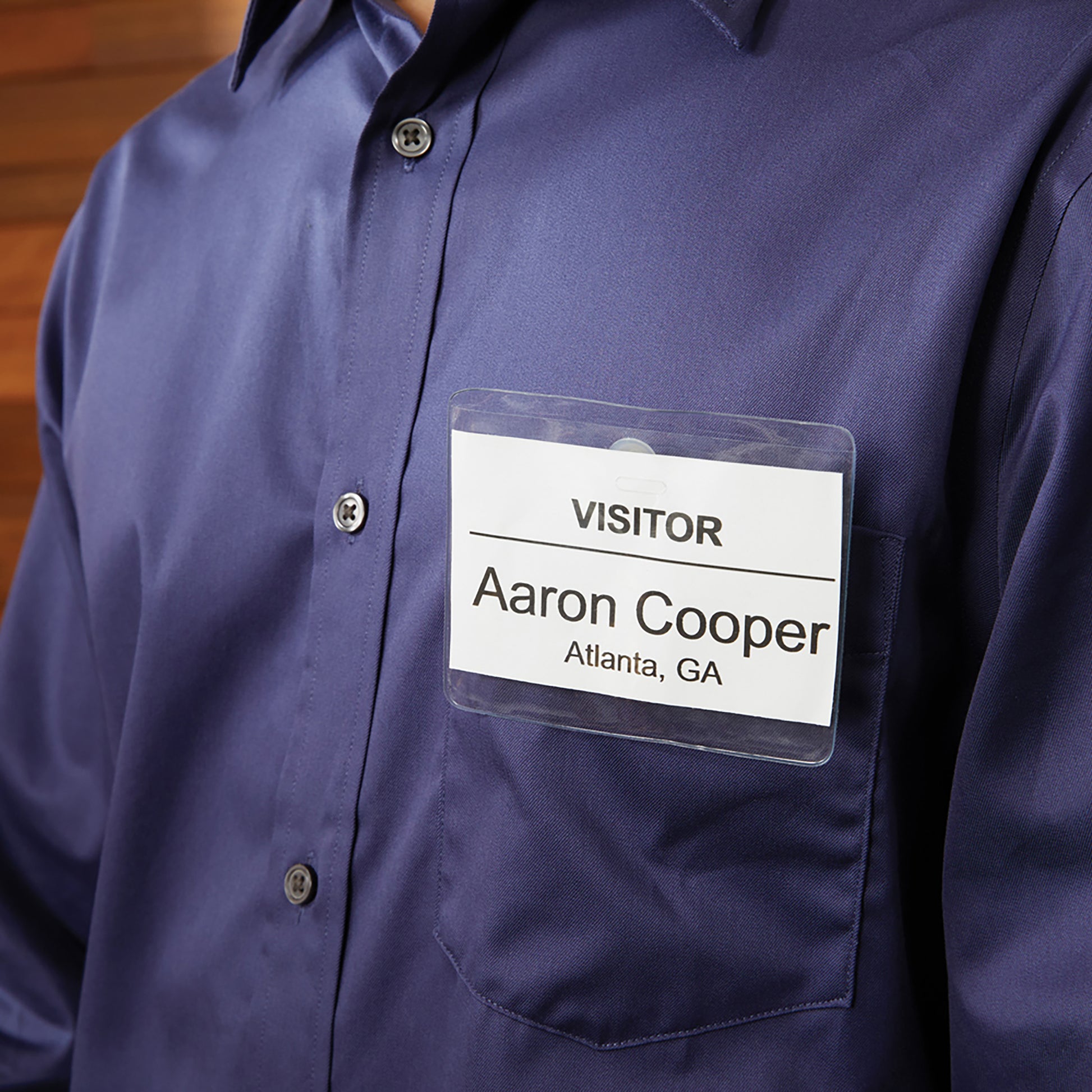 Visitor name badge on a blue shirt displaying Aaron Cooper from Atlanta, GA