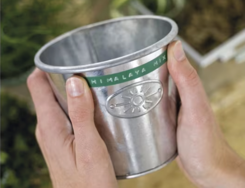 Metal bucket labelled with embossed tape for storage organisation