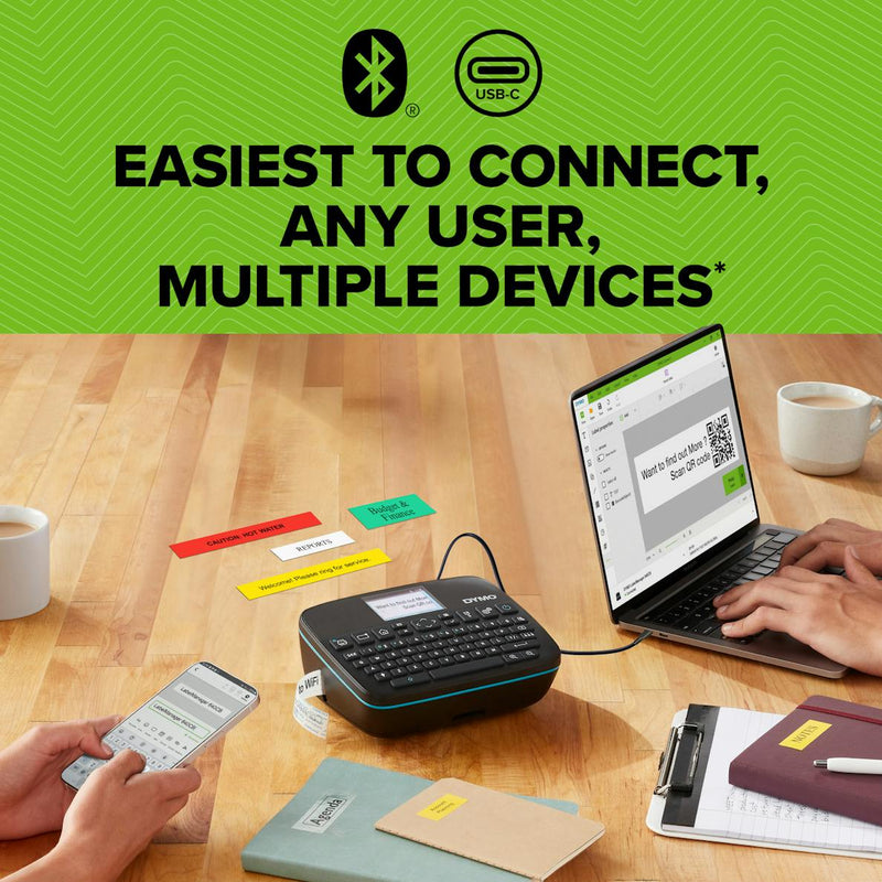 DYMO LabelManager user holding label maker with rechargeable battery and USB-C cable shown on desk