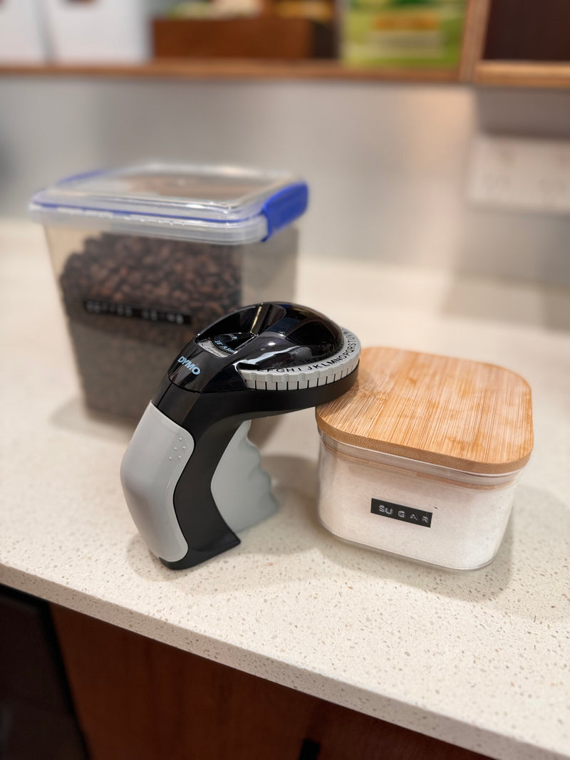 DYMO Organizer Xpress Pro embosser on a desk with labelled office accessories