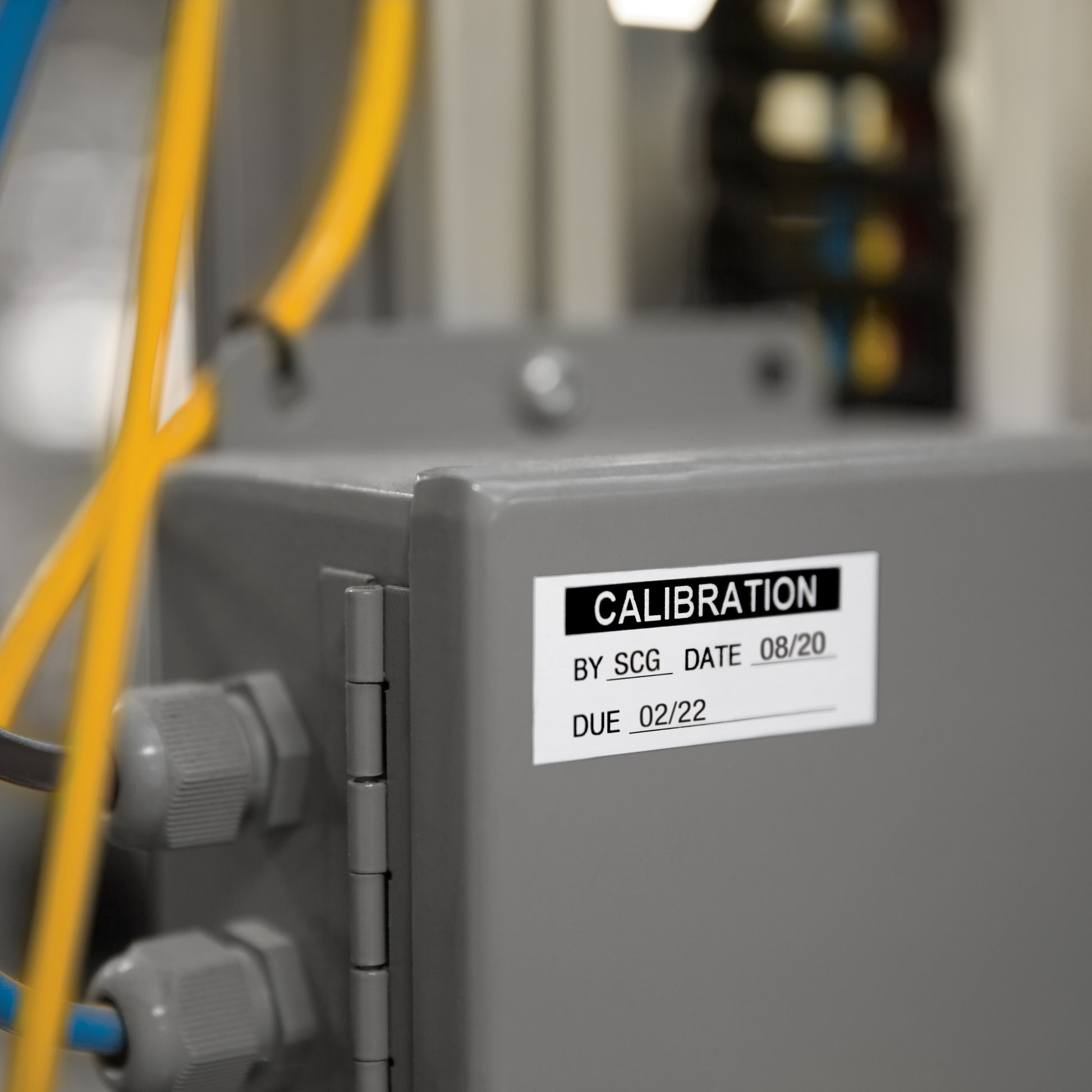 Calibration label applied to industrial electrical equipment with service date and due date fields
