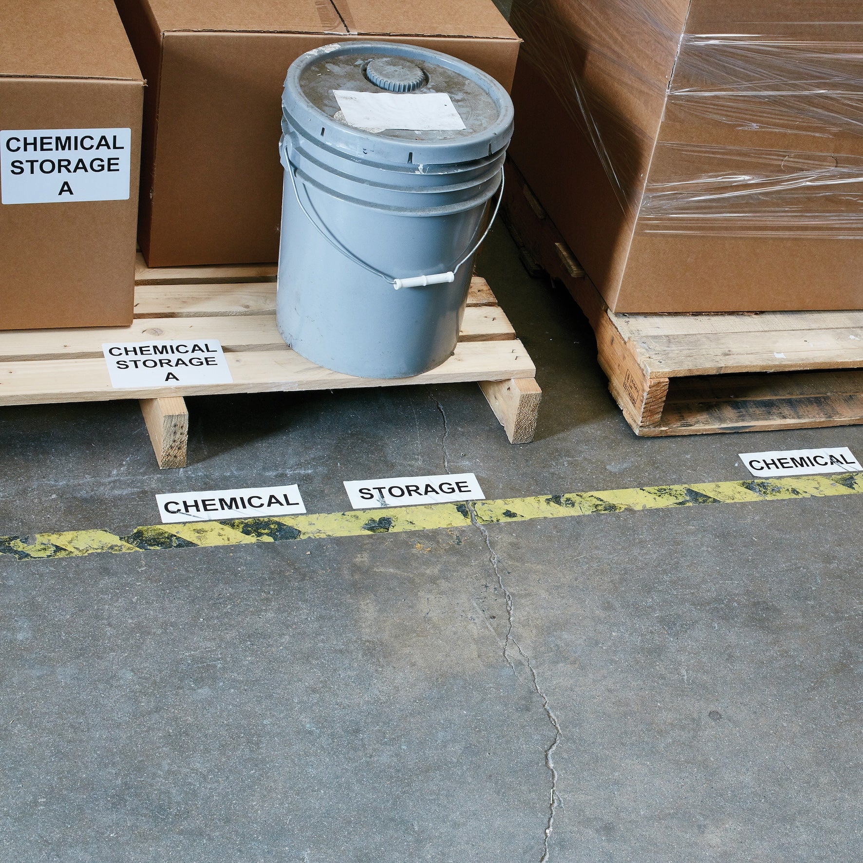 Warehouse floor and pallet storage area marked with DYMO chemical storage labels for organised industrial identification
