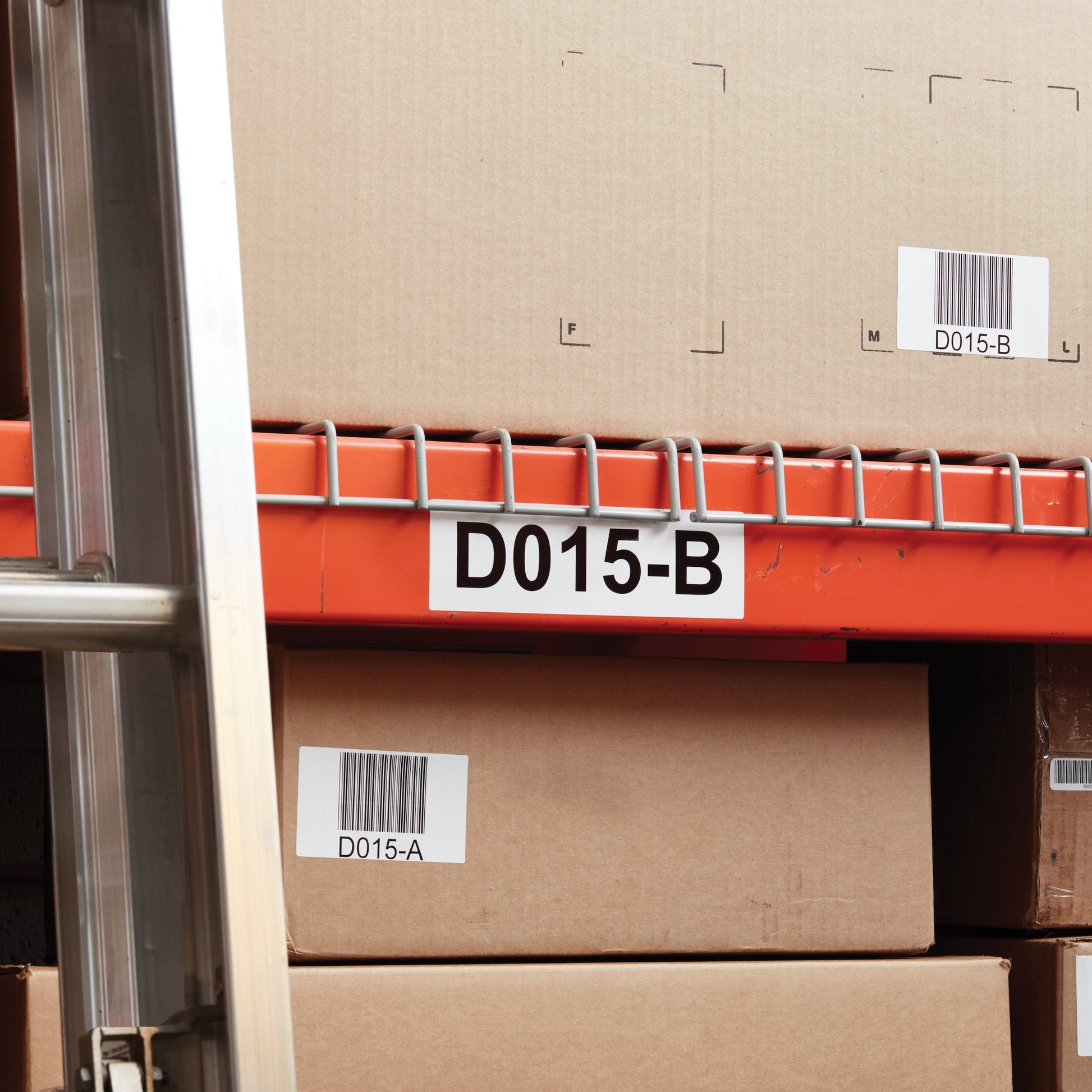 Warehouse shelf location label and barcode stickers applied to storage cartons and racking for inventory identification