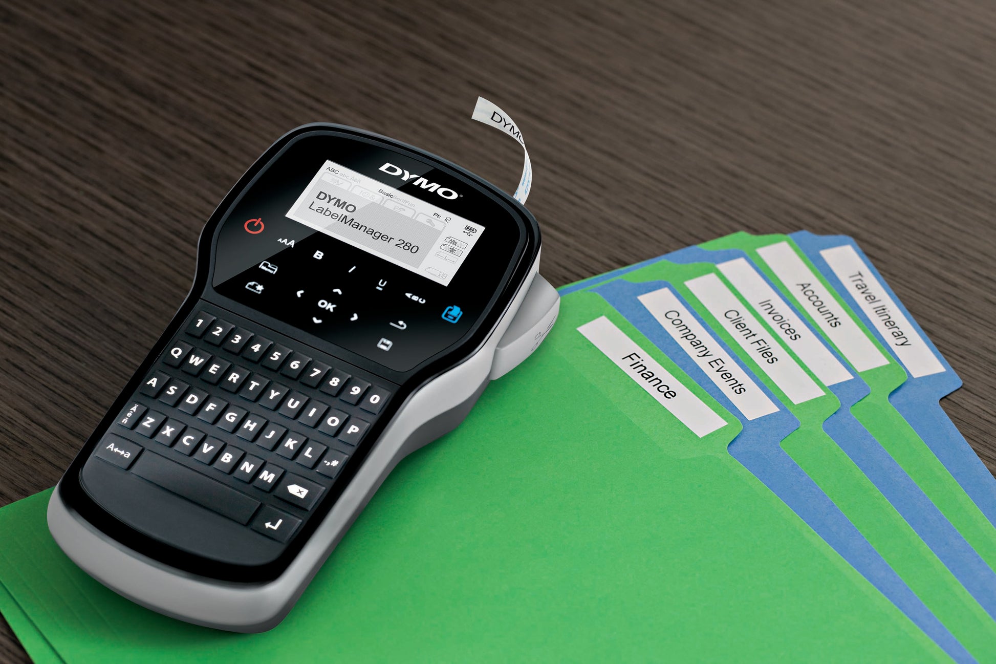 DYMO LabelManager 280 label maker beside colour coded file folders with printed filing labels for office organisation