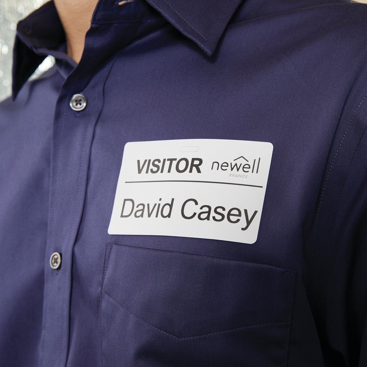 Visitor name badge printed on a 54 x 101mm Dymo label worn on a shirt